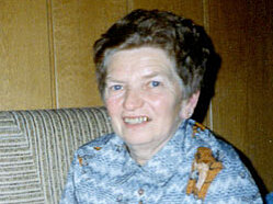 Rosa Weiler Portrait einer älteren Dame die milde lächelnd auf einer Couch sitzt, vor ihr ein Adventkranz