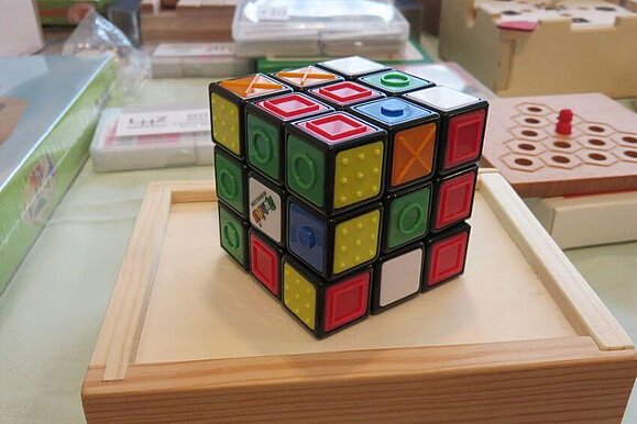 Durch taktile Markierungen können auch blinde und sehbeeinträchtigte Menschen den Knobelwürfel benutzen.