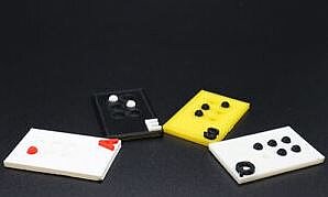 Braille_Plates.JPG Various squares in different colours with a letter written in braille above